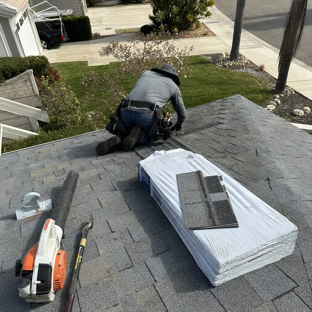 Roofing professional installing asphalt shingles during a residential roof repair project